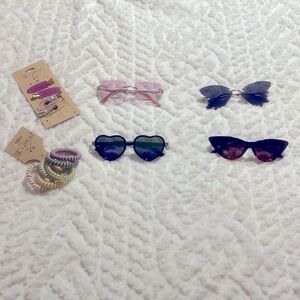 Four sunglasses for Women or Teenage Girls with some hair accessories.